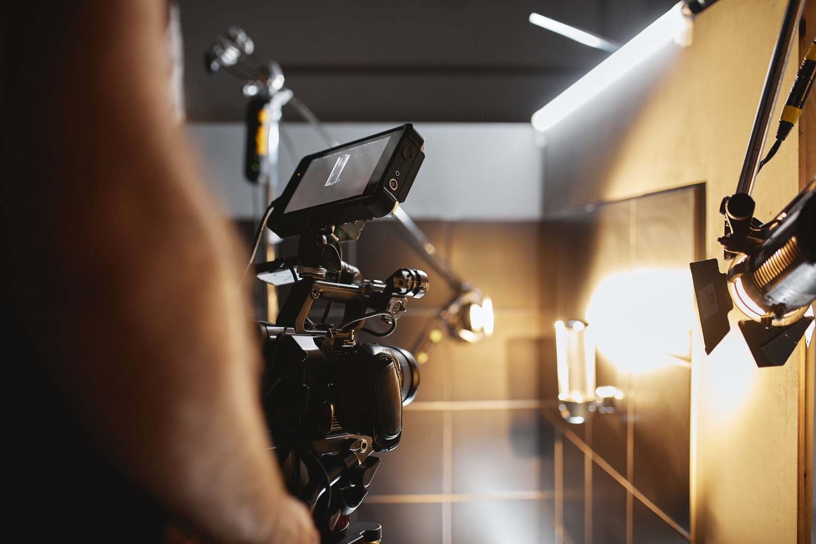 Video production backstage. Behind the scenes of creating video content, a professional team of cameramen with a director filming commercial ads. Video content creation, video creation industry, Low key, selective focus, film graine.