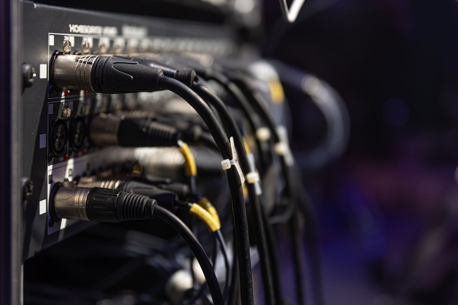 Audio snake and stage box with xlr cables and jacks at a live show.